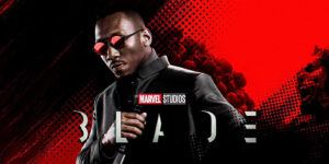 Promotional Marvel Studios Blade Poster Featuring a Man in a Black Suit with Red Sunglasses Holding a Microphone Against a Red black Halftone Background