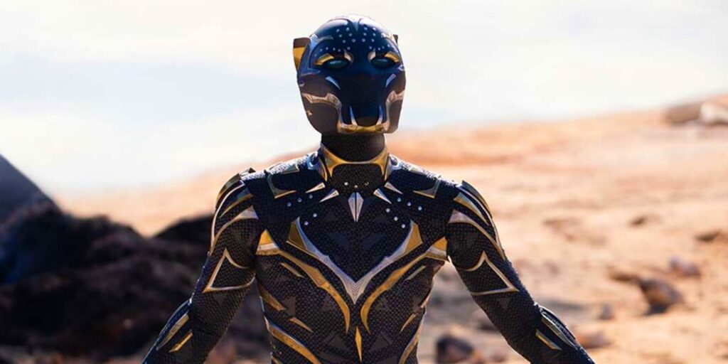 Futuristic Black and Gold Armored Humanoid Suit Stands in a Rocky Desert Landscape