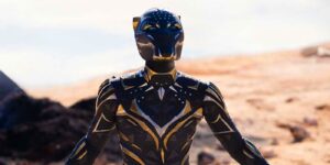Futuristic Black and Gold Armored Humanoid Suit Stands in a Rocky Desert Landscape