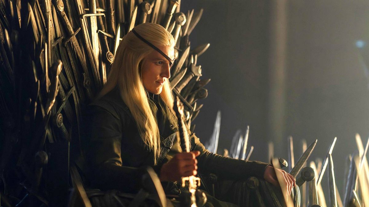 Cosplayer with Long Blonde Hair Sits on the Iron Throne a Throne Carved from Swords in a Dimly Lit Scene