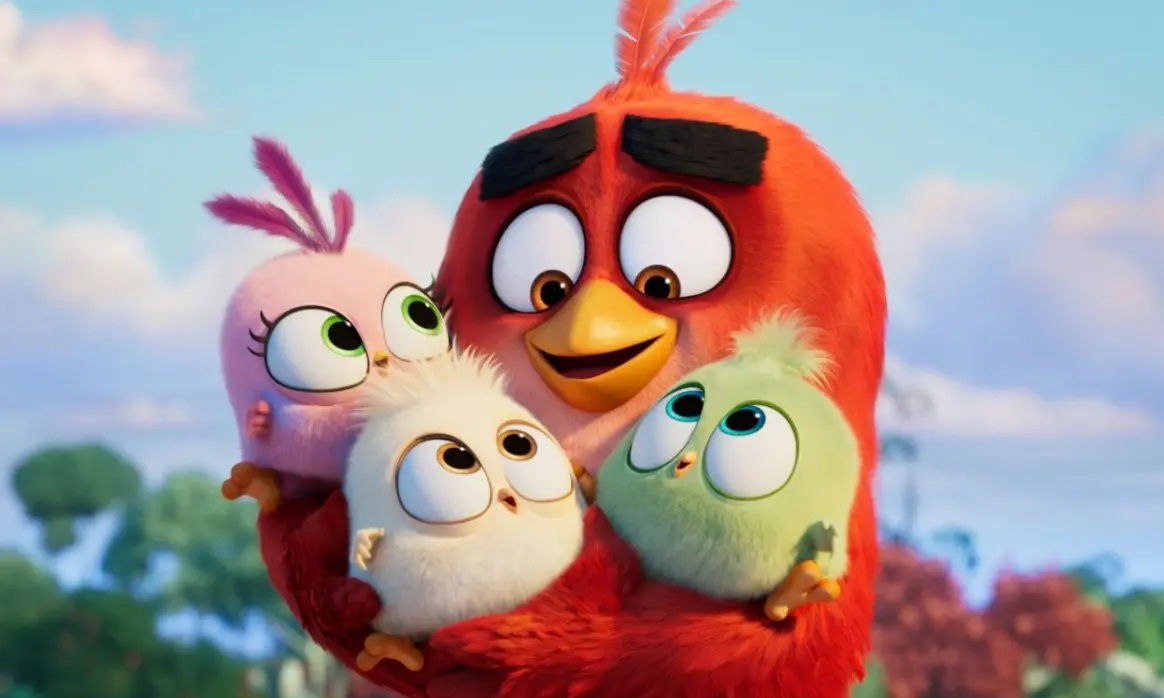 Red Large Bird Lovingly Hugs Three Fluffy Chicks Outdoors Conveying a Family Moment from an Animated Film