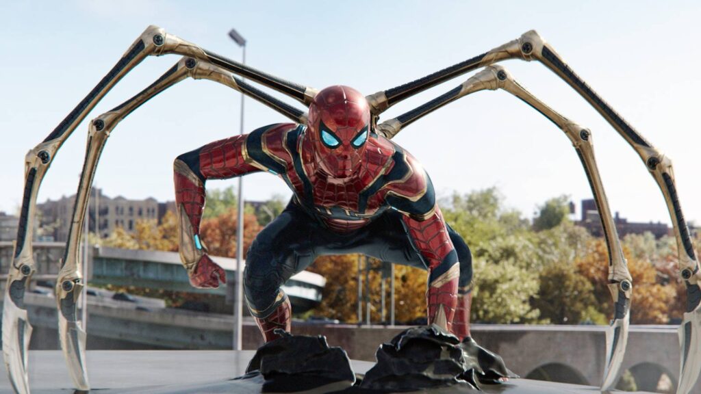 Spider man Crouching in Red Suit with Four Metallic Robotic Arms Extended Behind Him on a City Rooftop Set