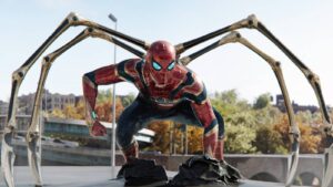 Spider man Crouching in Red Suit with Four Metallic Robotic Arms Extended Behind Him on a City Rooftop Set