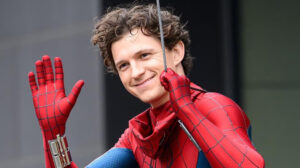 Person in a Spider man Suit Waves and Smiles at the Camera