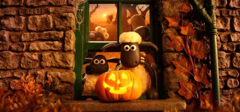 Two Shaun the Sheep Characters Peek Through a Window As a Glowing Jack o