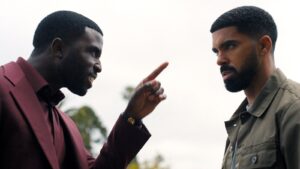 Two Men Face off Outdoors As One Points a Finger at the Other During a Tense Conversation Sunlight Behind Them