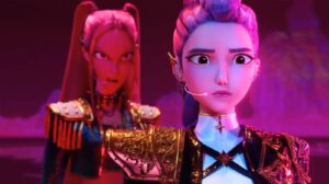 Two Animated Warriors in Ornate Armor Stand on a Pink lit Stage Foreground Character Looks Worried While Wearing a Headset Mic and Armor Details Are Gold and Blue