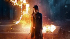 Young Woman in a School Uniform Standing with a Sword Surrounded by Flames and Embers in a Dark Scene