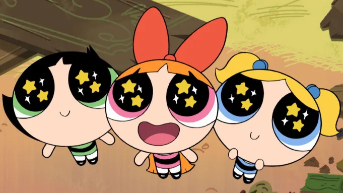 Three Powerpuff Girls with Oversized Starry Eyes Smiling Up at the Viewer Red Orange and Blue Bows in Their Hair