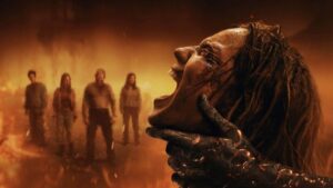 Monstrous Clawed Hand and Screaming Face Dominate a Fiery Smoky Scene with Four People Blurred in the Background