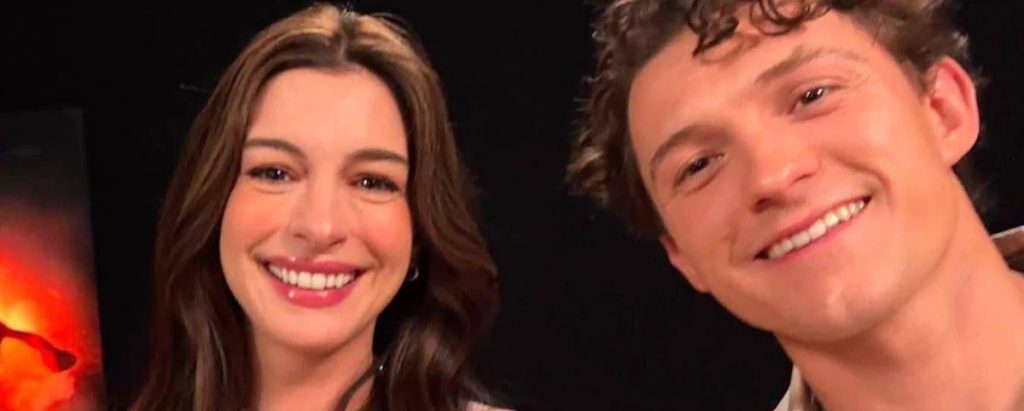 Two People Smiling for a Close up Selfie a Woman with Long Brown Hair on the Left and a Man with Short Curly Hair on the Right Both Looking at the Camera