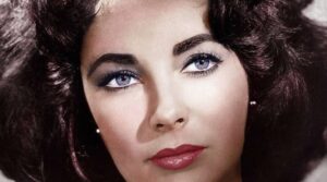 Close up Portrait of a Woman with Blue Eyes Dark Hair and Red Lipstick Looking to the Side