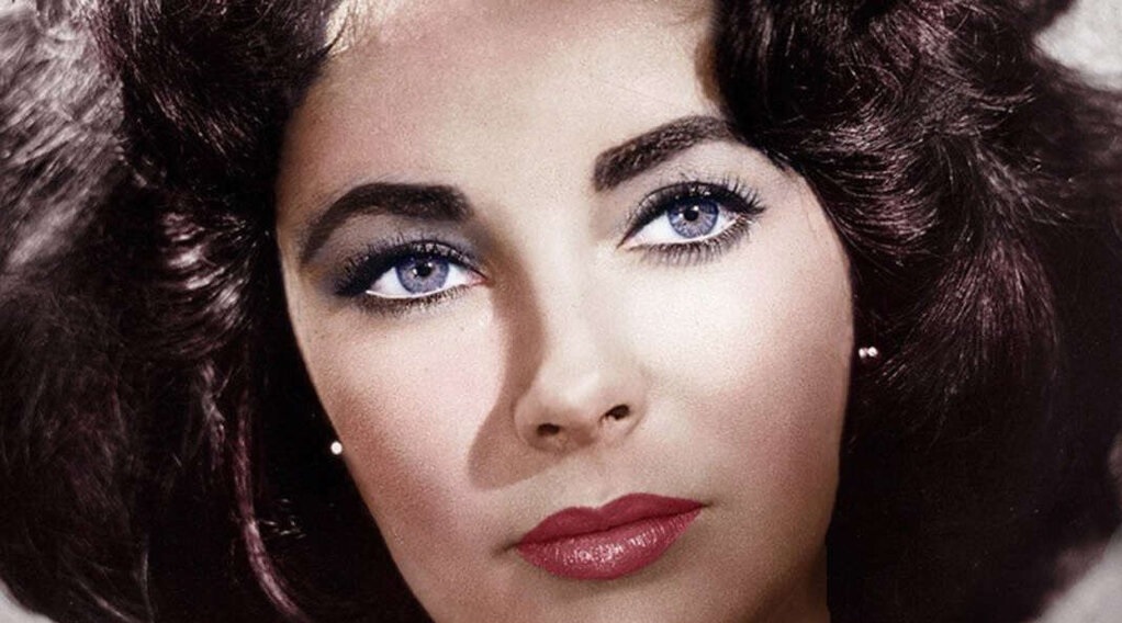 Close up Portrait of a Woman with Blue Eyes Dark Hair and Red Lipstick Looking to the Side