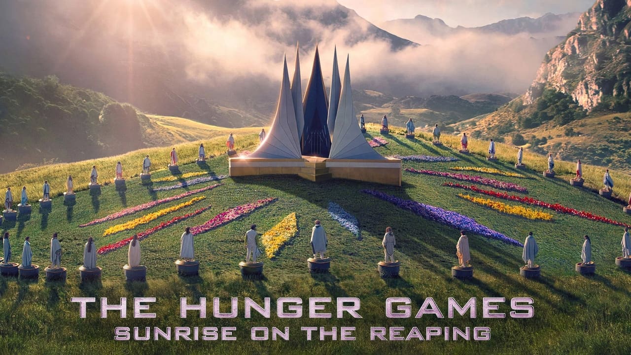 Promotional Poster for the Hunger Games Sunrise on the Reaping Showing a Sunlit Hill with Evenly Spaced Statue Figures Around a Central Multi spire Monument and Colorful Flower Beds