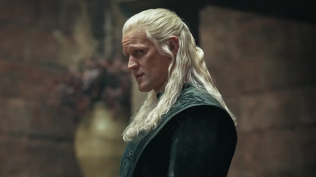 a Man with Long White Hair in Dark Medieval Armor Gazing to the Left in a Dimly Lit Interior