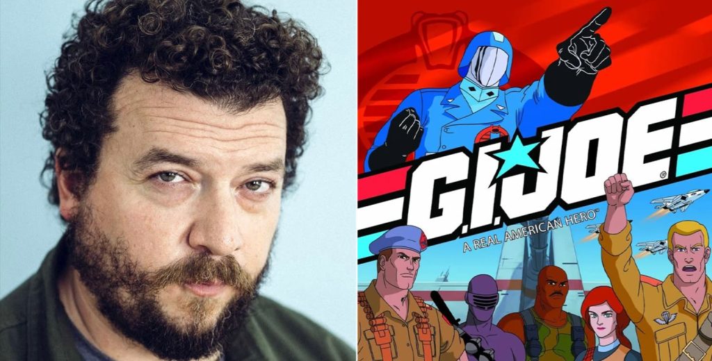 Portrait of a Man with Curly Dark Hair and Beard Beside a Colorful Gi Joe Comic Cover with the Title