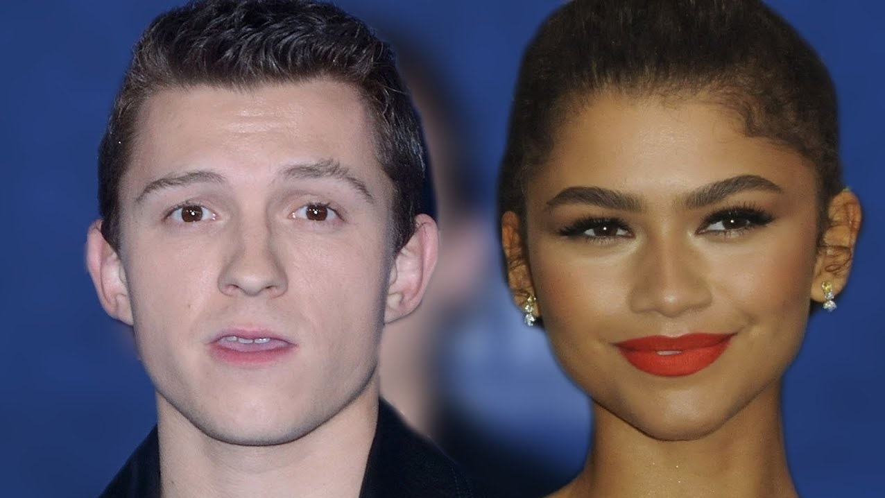 Side by side Portraits Man on the Left with Short Dark Hair and Light Skin Woman on the Right with a Bun Red Lipstick Earrings Against a Blue Background