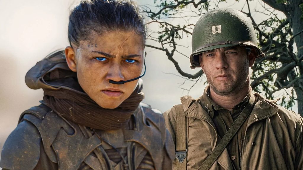 Two Soldiers in Dusty Combat Gear Stand Close Together Looking Intently at the Camera in a Barren Outdoor Setting