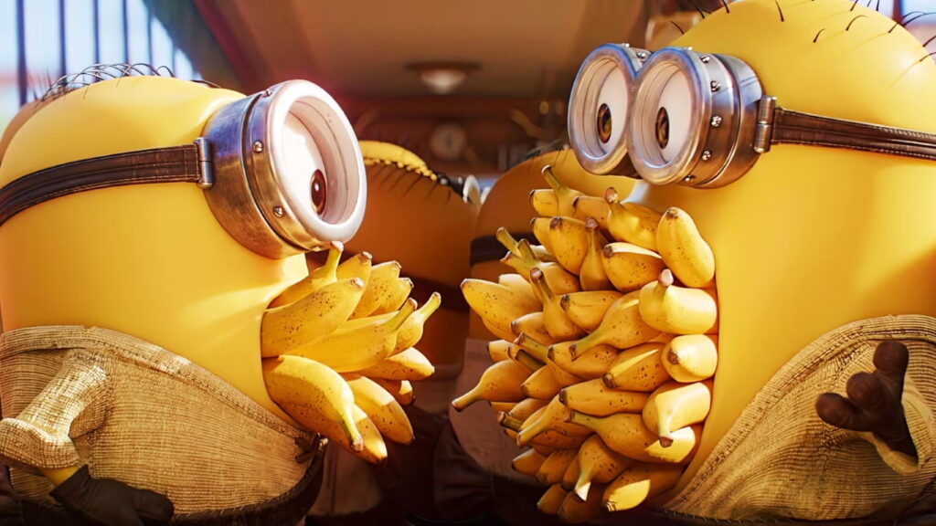 Two Minions Wearing Goggles Facing Each Other with Large Bunches of Bananas Around Their Chests in a Playful Scene