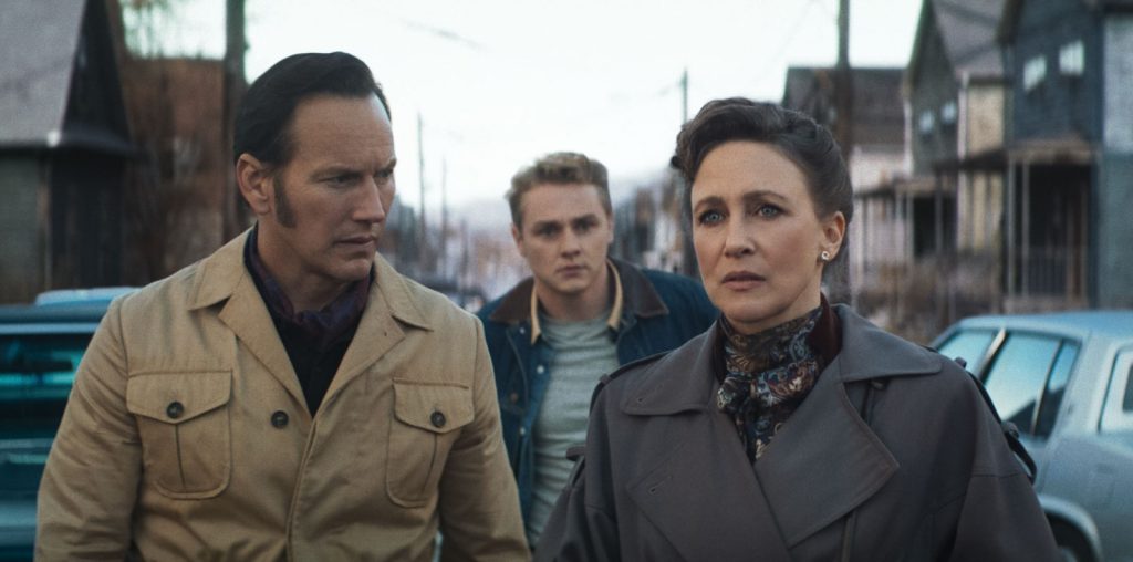 Three Adults Walk Down a Vintage era Street Two Men Flank a Worried Woman in the Foreground