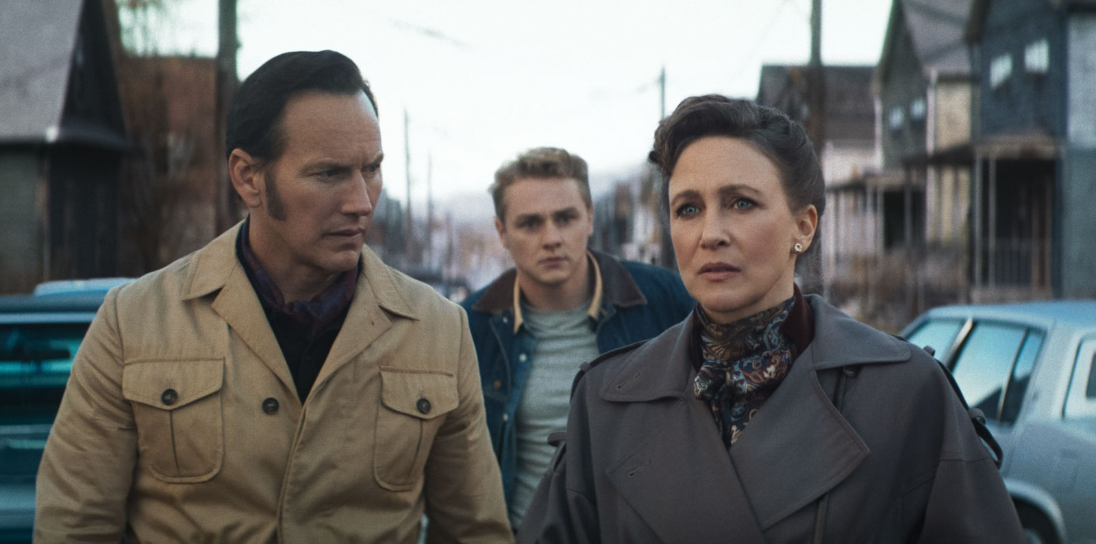 Three Adults Walk Down a Vintage era Street Two Men Flank a Worried Woman in the Foreground