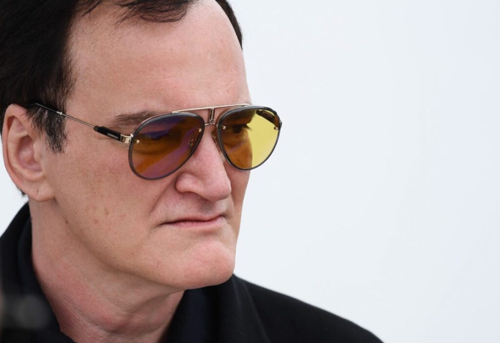 Close up Portrait of a Man Wearing Aviator Sunglasses and a Black Jacket Looking to the Right