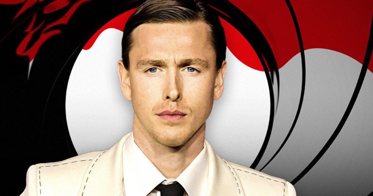 Close up of a Man Wearing a Cream Suit and Black Tie Posed Against an Abstract Red Black and Gray Background